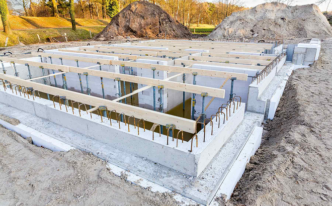 Concrete foundations construction site with workers and equipment